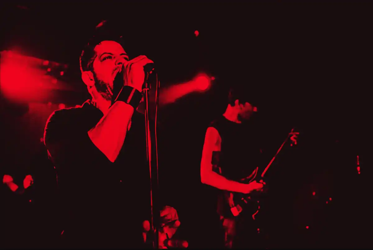 Worship Pain performing live under red light