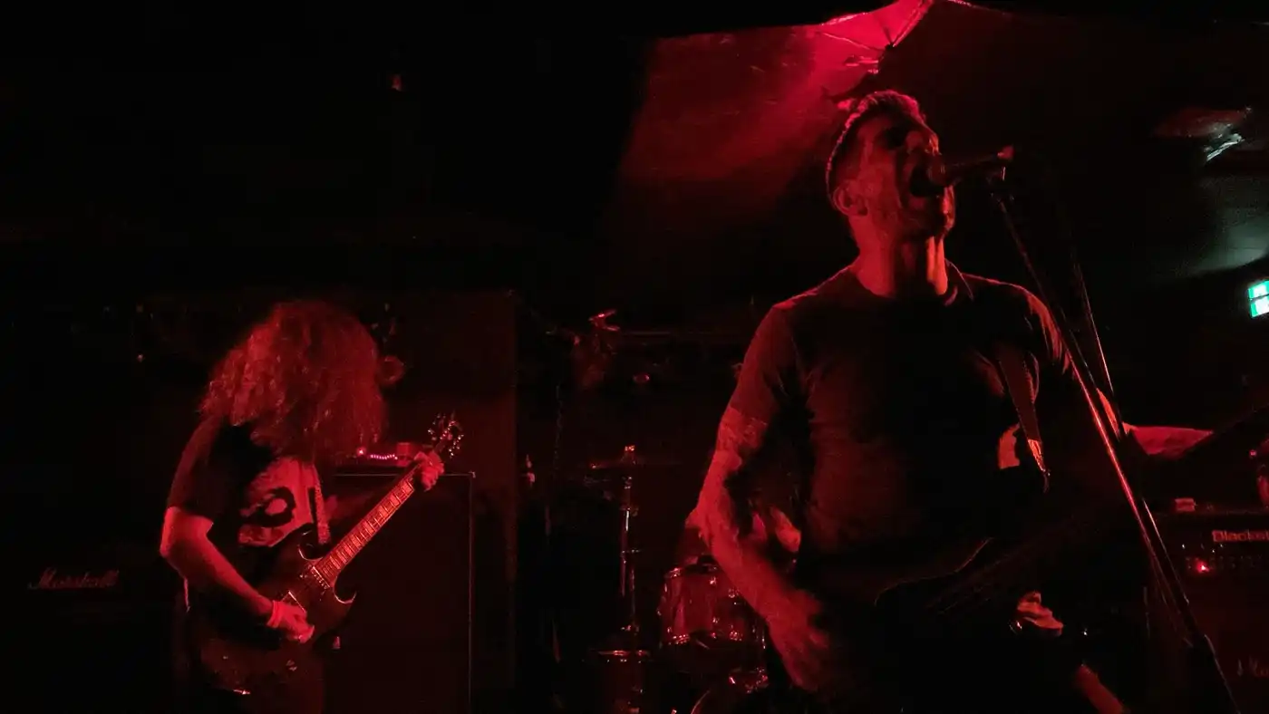 Worship Pain performing in a dark live room
