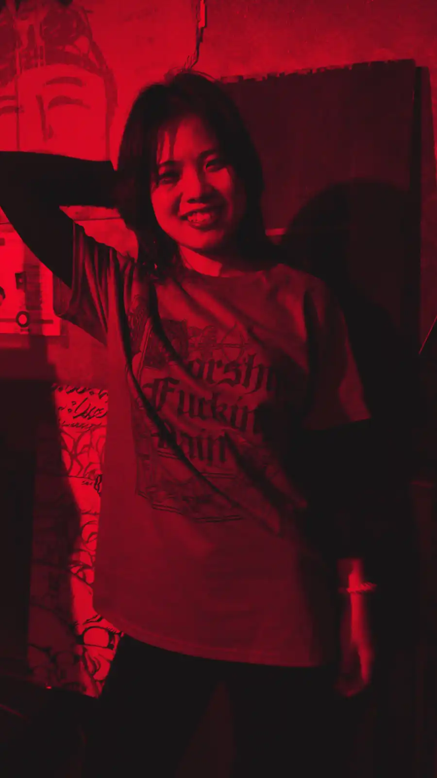 Worship Pain merch shirt under red light