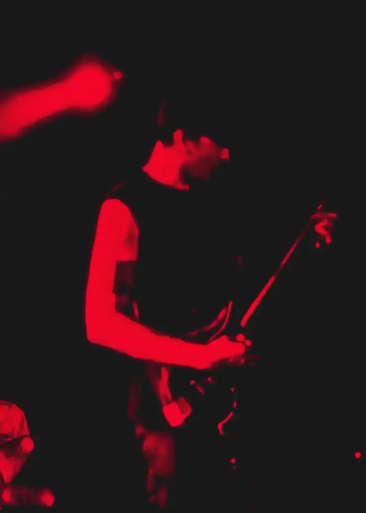 Jordan performing live for Worship Pain under severe red light