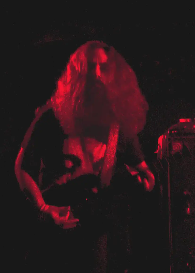 Matt performing live for Worship Pain under red stage light