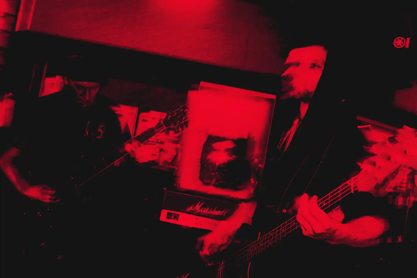 Worship Pain members inside a studio under red light